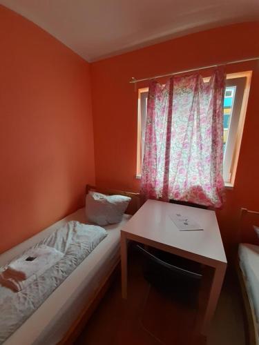 a small room with a bed and a desk and a window at 2-Rent Group Hostel Rooms&Apartments TUB19A in Munich