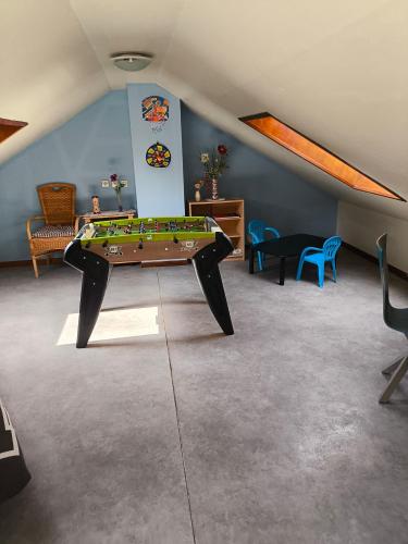 a room with a table in the middle of a room at Au P'tit Gouy in Gouy-Saint-André