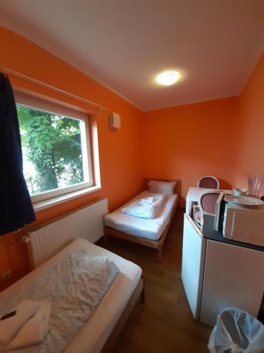 a small room with two beds and a window at 2-Rent Group Hostel Rooms&Apartments TUB19A in Munich
