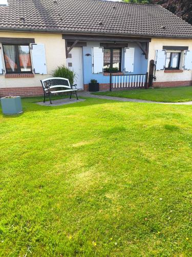 a bench in a yard in front of a house at Au P'tit Gouy in Gouy-Saint-André
