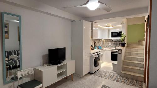 a living room with a television and a kitchen at 009 Bungalow La Mata in La Mata
