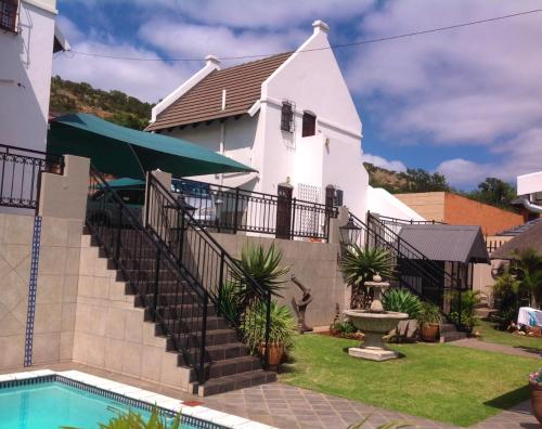 a house with a swimming pool and a church at Montana Cape House in Pretoria