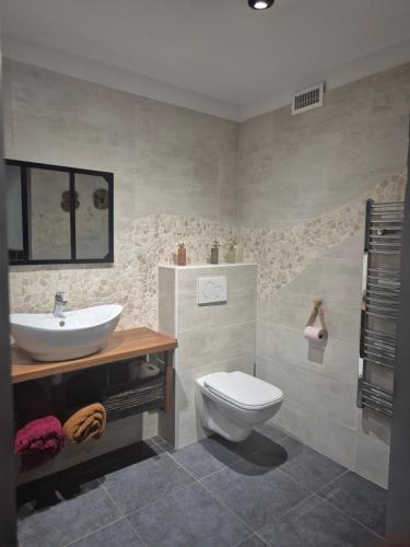 a bathroom with a white toilet and a sink at chambre d'hôte d'artiste in Mandelieu-la-Napoule