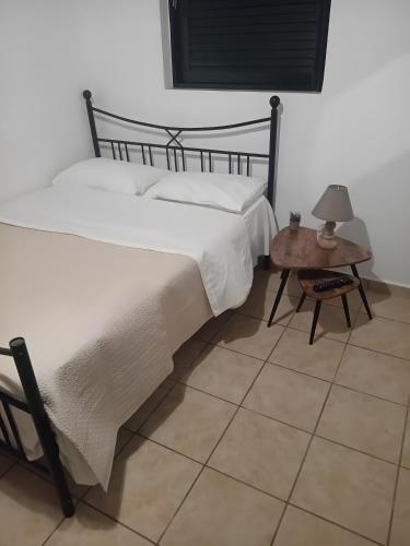 a bedroom with a large bed and a table at Mouria Studio C in Kithnos