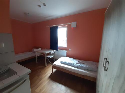 a small room with a bed and a window at 2-Rent Group Hostel Rooms&Apartments TUB19A in Munich
