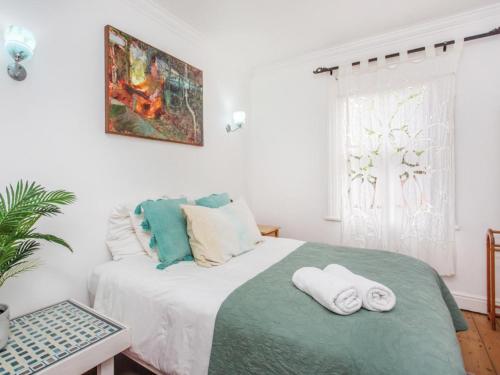 a bedroom with a bed with towels on it at St James Beachfront Villa in St James