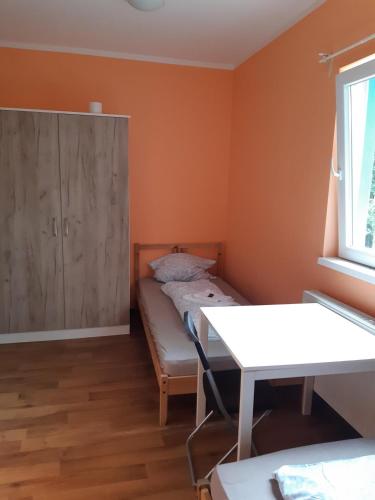 a small room with a bed and a cabinet at 2-Rent Group Hostel Rooms&Apartments TUB19A in Munich