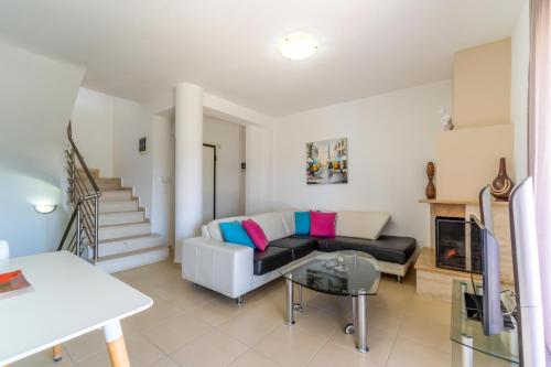a living room with a couch and a table at Paliouri Villas in Paliouri