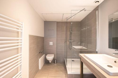 a bathroom with a shower and a toilet and a sink at Charming studio at the foot of the Opera-Le Petit Pradel in Lyon