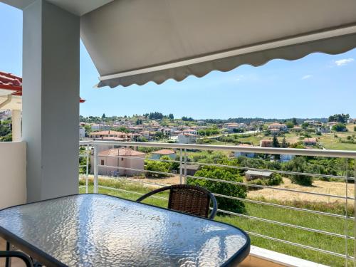 a balcony with a table and a view of the city at Paliouri Villas in Paliouri
