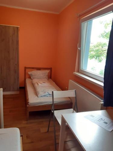 a small room with a bed and a window at 2-Rent Group Hostel Rooms&Apartments TUB19A in Munich