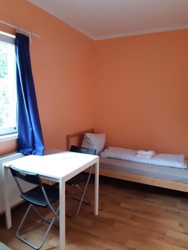 a room with a bed and a table and a window at 2-Rent Group Hostel Rooms&Apartments TUB19A in Munich