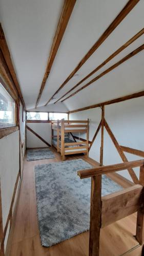 a room with two bunk beds and a rug at Planinska kuća Bajni 