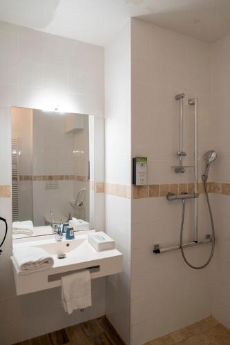 a bathroom with a sink and a shower at Kyriad Nuits Saint Georges Dijon Sud in Nuits-Saint-Georges