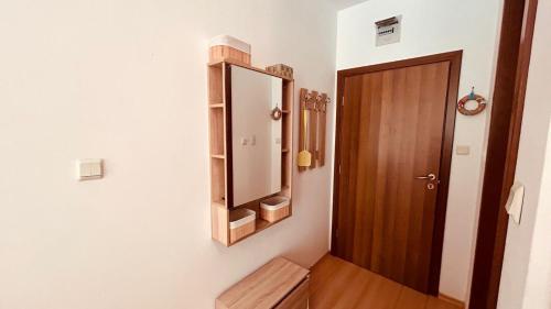 a bathroom with a mirror and a wooden door at Sunny Day 6 Studio 11 in Sunny Beach