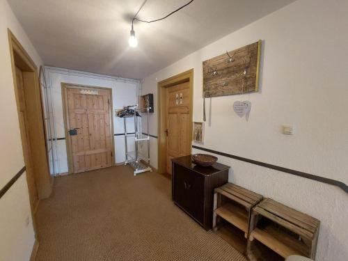 an empty room with a bench and a door at Ferienwohnung - Das Boarding House in Lemgo
