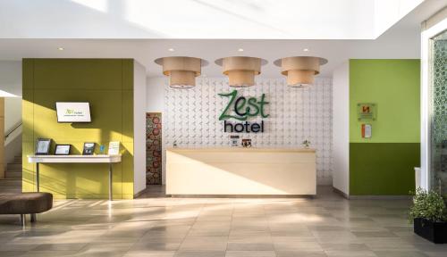 a restaurant lobby with a lost hotel sign on the wall at Zest Harbour Bay Batam by Swiss-Belhotel International in Nagoya
