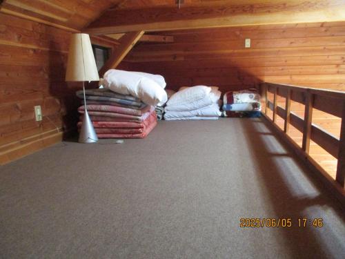 a attic room with a bed and a lamp at Sun Lake in Fujikawaguchiko