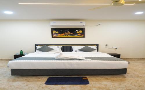 a bedroom with a large bed with a blue rug at Madhura Luxury Rooms in Hyderabad