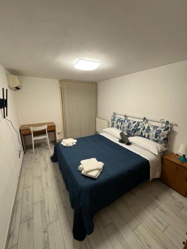 a bedroom with a bed with two towels on it at Dimoretta house - Penthouse with a view of Mount Etna in Catania