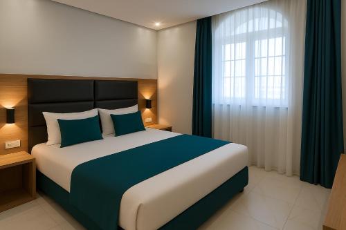 a bedroom with a large bed and a window at Hotel Babylon Royal in Ringsheim