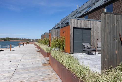a building with a garage next to the water at Varvet Sea View Suites by Ålandhotels in Mariehamn