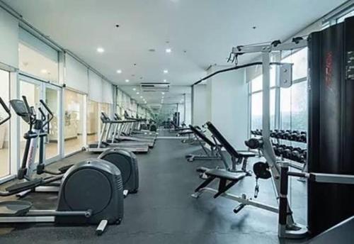 a gym with a row of treadms and machines at QuiHouse in Manila