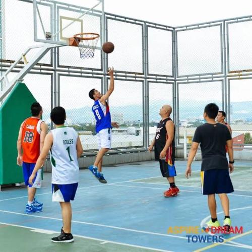 a group of men playing basketball on a court at QuiHouse in Manila