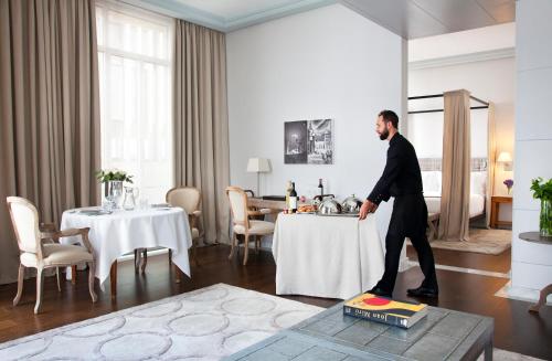 a man in a suit is standing at a table at URSO Hotel & Spa, a Small Luxury Hotel of the World in Madrid