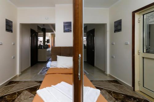 a room with two beds and a mirror at Luxury Panorama pyramids & jacuzzi in Cairo