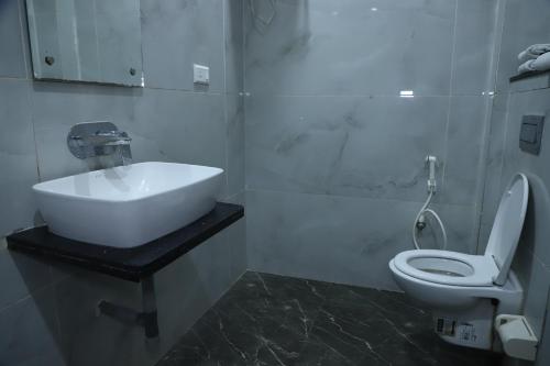 a bathroom with a sink and a toilet at Hotel Akash Inn Agra I 200 m From Taj Mahal in Agra