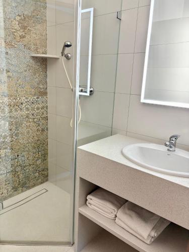 a bathroom with a shower and a sink at Camping Morski 21 in Łeba