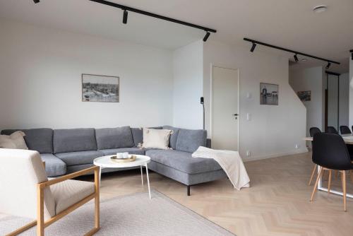 a living room with a couch and a table at Varvet Sea View Suites by Ålandhotels in Mariehamn