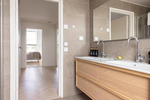 a bathroom with a sink and a mirror at Varvet Sea View Suites by Ålandhotels in Mariehamn
