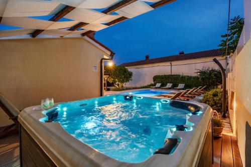 a jacuzzi tub on a patio at night at Villa Katja near Pula with whirlpool only 3 km from the beach in Krnica
