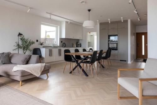 a living room and kitchen with a table and chairs at Varvet Sea View Suites by Ålandhotels in Mariehamn