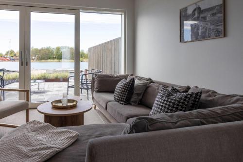 a living room with a couch and a table at Varvet Sea View Suites by Ålandhotels in Mariehamn