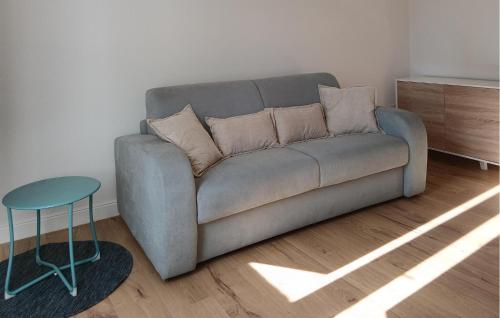 a couch in a living room with a table and a stool at 1 Bedroom Nice Apartment In Casalguidi in Cantagrillo