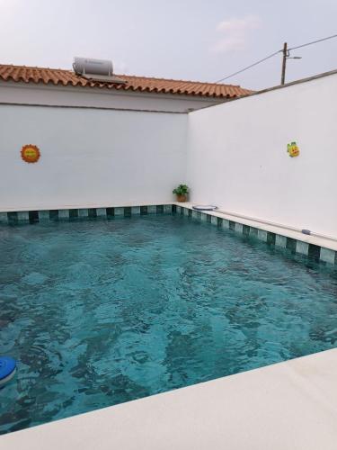 a swimming pool in a white room with blue water at O Cantinho dos Avós in Carrapatelo