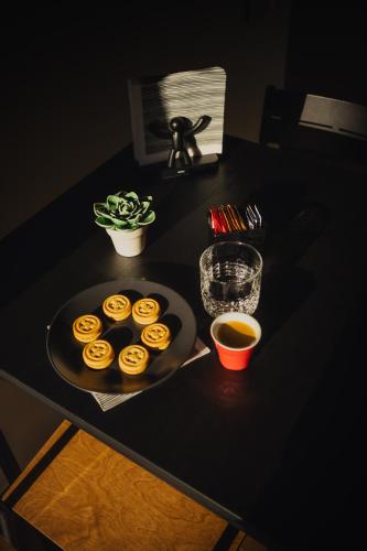 a table with a plate of donuts on a table at Talisia - central apartment in Taranto