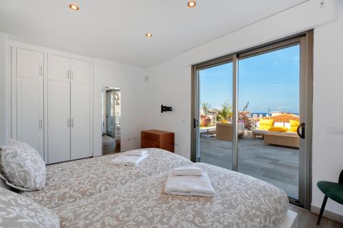 En eller flere senge i et værelse på Villa Arenas 3 Playa la Arena