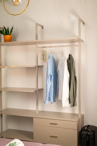 a closet with white shelves and clothes at San Gennaro House in Pozzuoli