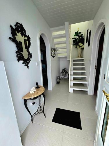 a hallway with a table and stairs in a house at The Cedar Tree House in Sete Cidades
