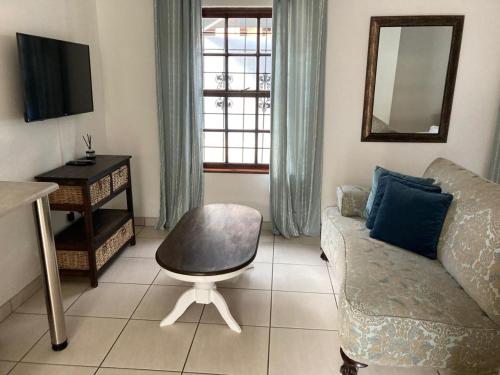 a living room with a couch and a chair at Montana Cape House in Pretoria