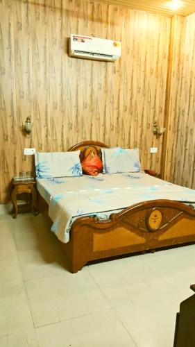 a dog laying in a bed in a room at Hotel Sandalwood in Amritsar