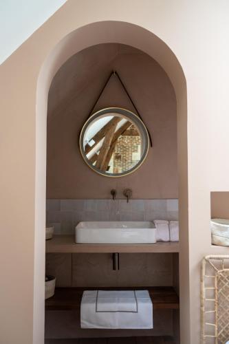 a bathroom with a sink and a mirror at Les Écuries de Juranville in Bourges