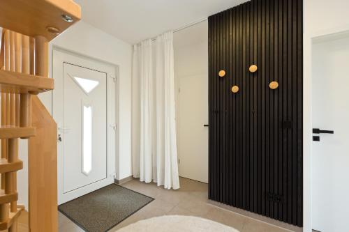 a hallway with a black closet and a staircase at Seegasse in Göhren-Lebbin