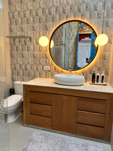 a bathroom with a sink and a mirror at Studio Guesthouse No 39 in Lovina