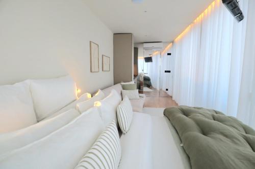 a white living room with a white couch at Villa La Finca - Gerês in Vieira do Minho