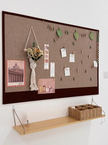 a wall with a bulletin board and a basket on a shelf at MokuMoku Miri Homestay FOC Netflix & Ytb 18pax in Miri